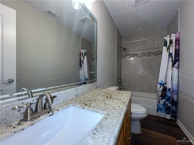 full bathroom featuring wood-type flooring, vanity, toilet, and shower / tub combo with curtain