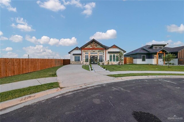2208 Trinity St, Donna, TX 78537 - view of front of home with concrete driveway and stone siding