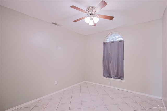 spare room with light tile patterned floors, ceiling fan, baseboards, and visible vents