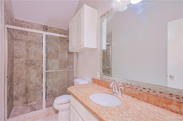 bathroom with a stall shower, toilet, tile patterned flooring, and vanity