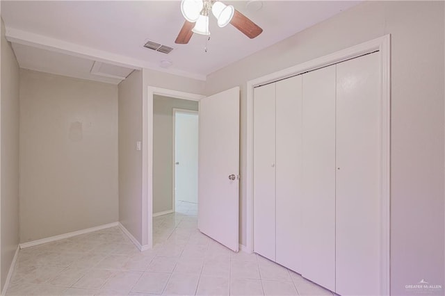 unfurnished bedroom featuring light tile patterned floors, visible vents, baseboards, and a closet