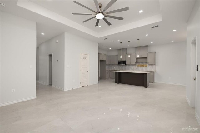 9206 N 25th St, Mcallen, TX 78504 - unfurnished living room with a tray ceiling, recessed lighting, and a ceiling fan