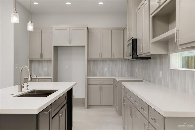 9206 N 25th St, Mcallen, TX 78504 - kitchen with gray cabinets, recessed lighting, an island with sink, and backsplash