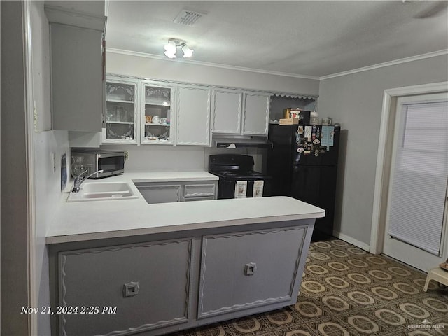 kitchen featuring sink, kitchen peninsula, white cabinets, black appliances, and ornamental molding