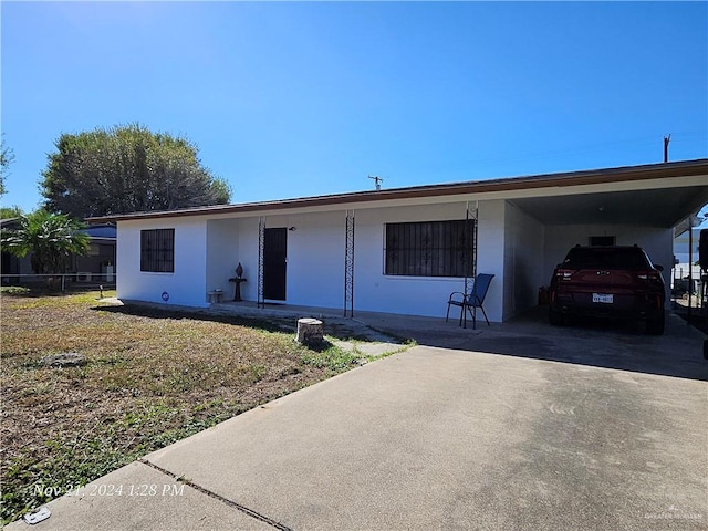 ranch-style home with a carport