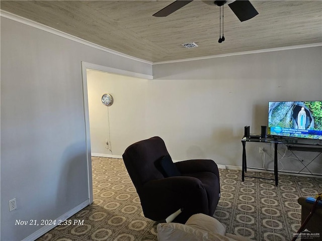 living area featuring ceiling fan and ornamental molding