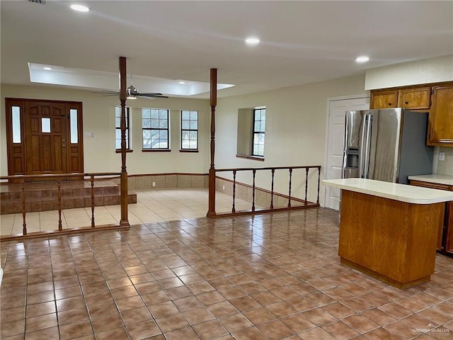 5307 Fm 493rd Rd, Donna, TX 78537 - kitchen with stainless steel fridge with ice dispenser, recessed lighting, light countertops, a kitchen island, and brown cabinetry