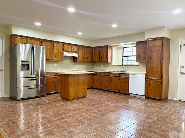 5307 Fm 493rd Rd, Donna, TX 78537 - kitchen with stainless steel fridge with ice dispenser, white dishwasher, brown cabinetry, under cabinet range hood, and recessed lighting