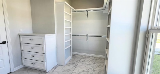 spacious closet featuring marble finish floor