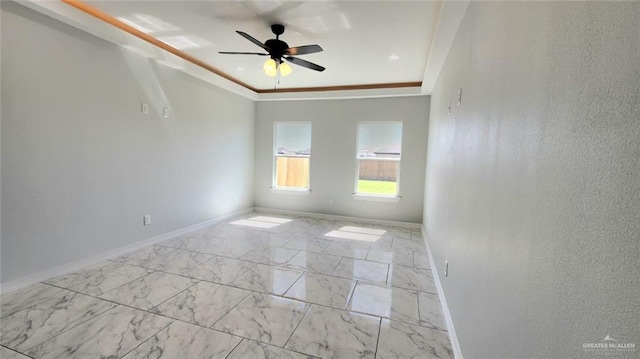 spare room with baseboards, ceiling fan, and marble finish floor