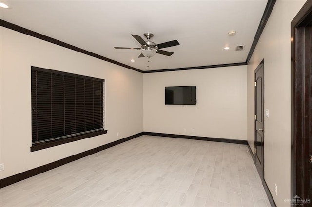 unfurnished room featuring a ceiling fan, visible vents, ornamental molding, and baseboards