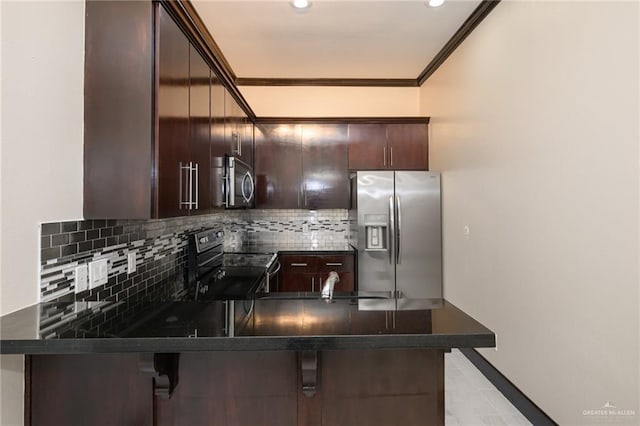 kitchen featuring stainless steel appliances, dark countertops, ornamental molding, and dark brown cabinets