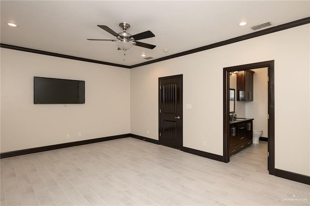 spare room with ceiling fan, ornamental molding, visible vents, and baseboards