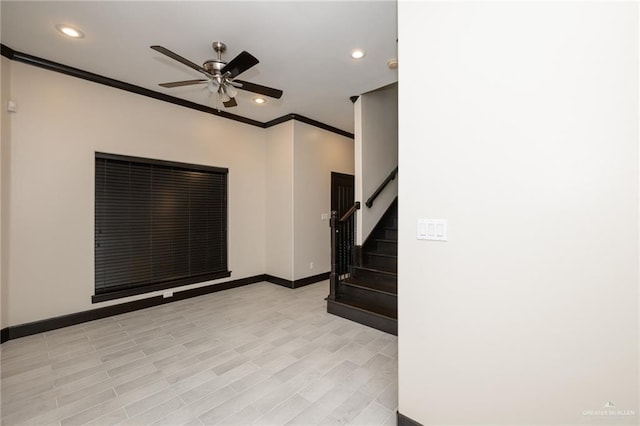 spare room with recessed lighting, a ceiling fan, baseboards, stairway, and crown molding