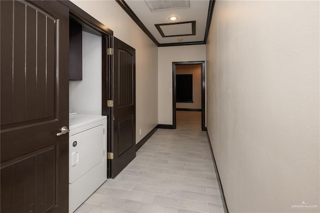 hall featuring visible vents, baseboards, washer / dryer, and crown molding