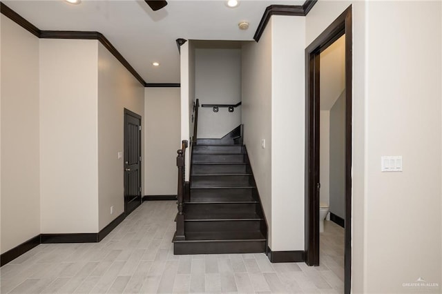 stairs with ornamental molding, recessed lighting, and baseboards