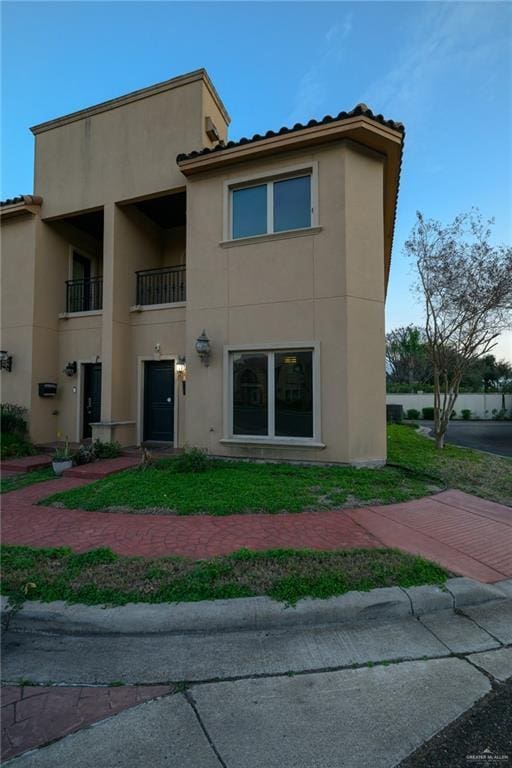 rear view of property featuring stucco siding