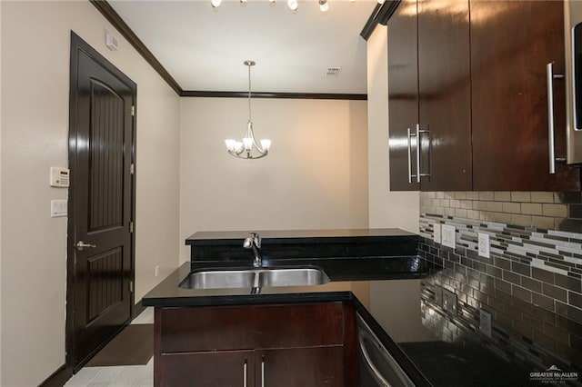 kitchen with dark brown cabinetry, a peninsula, a sink, ornamental molding, and dark countertops