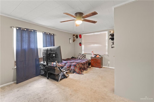 carpeted bedroom with ceiling fan and ornamental molding