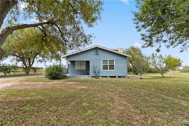 exterior space with a porch and a front yard