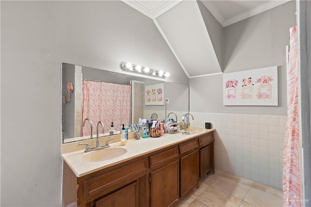 bathroom with tile patterned floors, crown molding, vanity, and tile walls