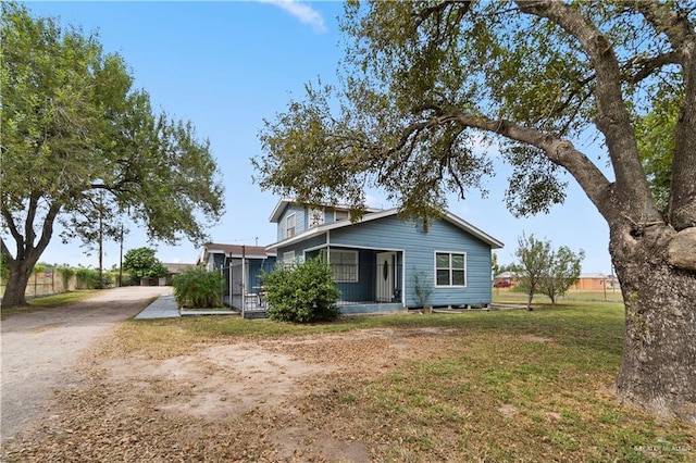 view of front of home featuring a front yard and a sunroom