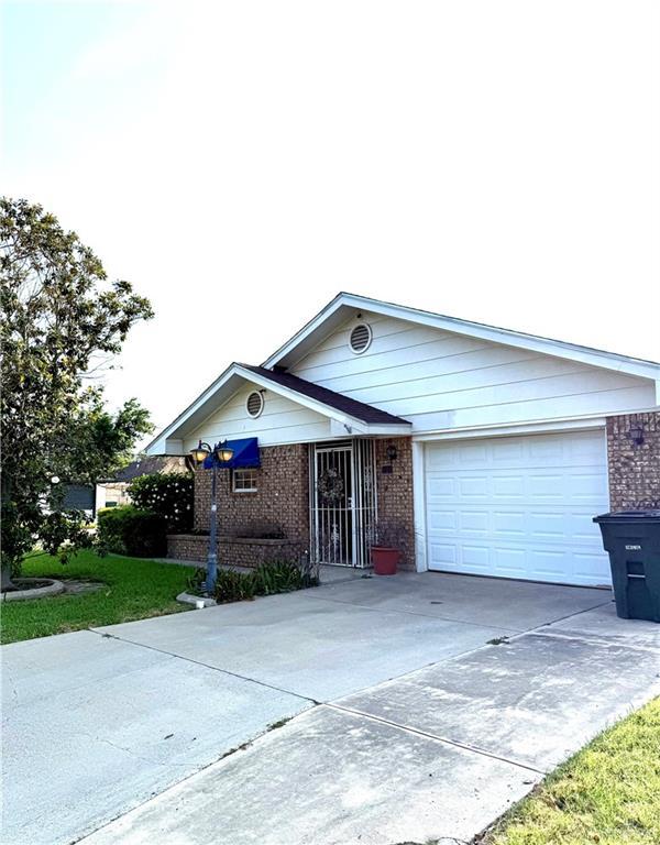 2303 Viola St, Mission, TX 78574 - ranch-style home with brick siding, a garage, and driveway