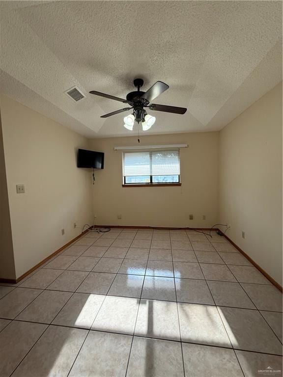 2303 Viola St, Mission, TX 78574 - unfurnished room with ceiling fan, a textured ceiling, baseboards, light tile patterned floors, and visible vents