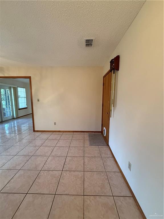 2303 Viola St, Mission, TX 78574 - unfurnished room featuring visible vents, baseboards, a textured ceiling, and light tile patterned floors