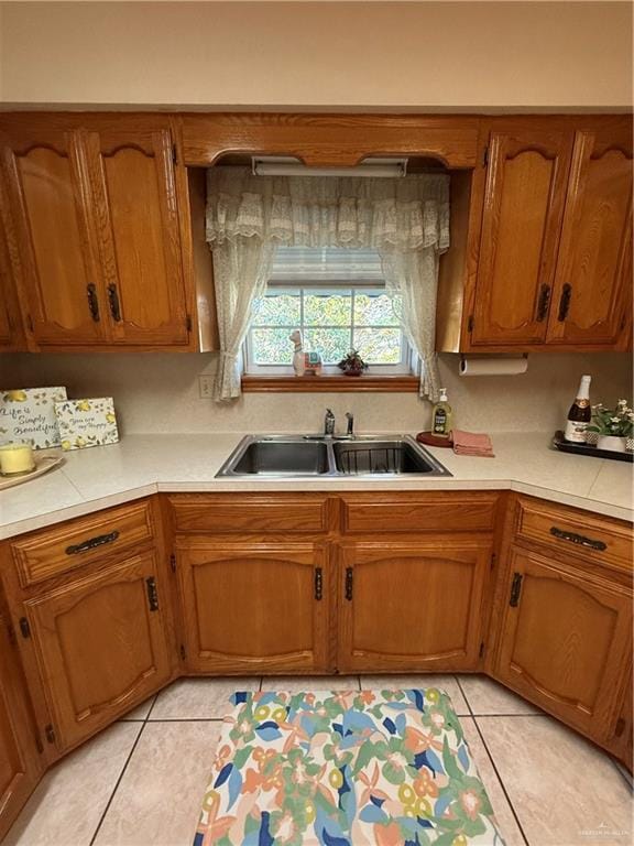 2303 Viola St, Mission, TX 78574 - kitchen featuring brown cabinetry, light countertops, and light tile patterned floors