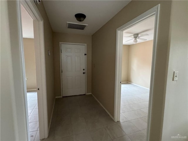 hall with light tile patterned flooring