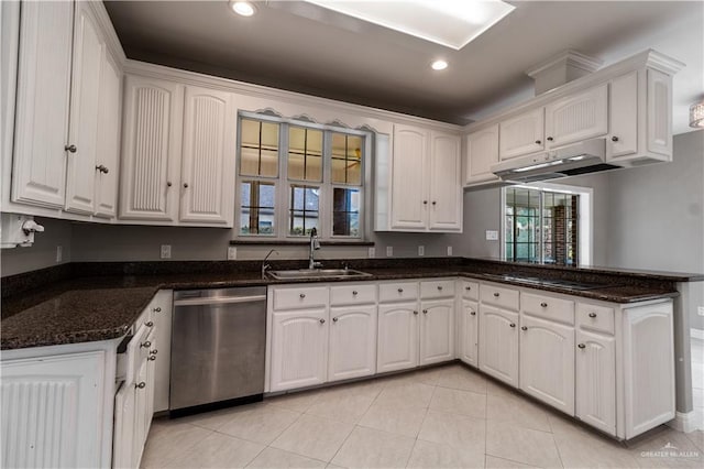 kitchen featuring light tile patterned floors, a peninsula, white cabinets, dishwasher, and a sink