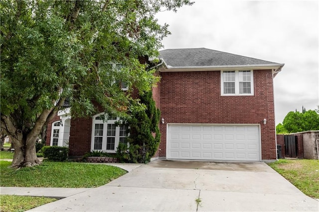 view of front of property with brick siding, a front yard, an attached garage, and concrete driveway