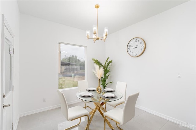 dining area featuring light tile patterned flooring and an inviting chandelier