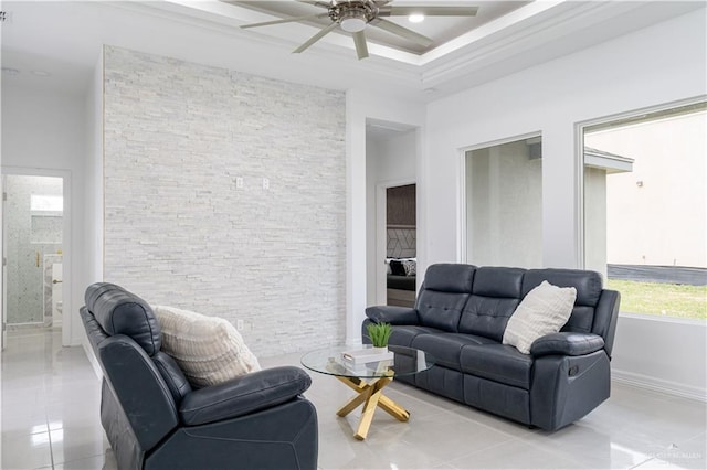 tiled living room with ceiling fan