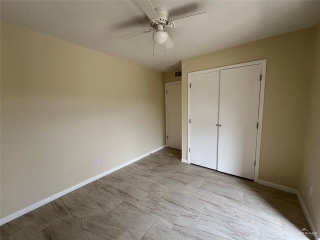 unfurnished bedroom with a ceiling fan, a closet, visible vents, and baseboards