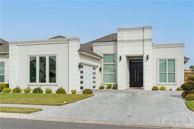 view of front of property with a front lawn and a garage