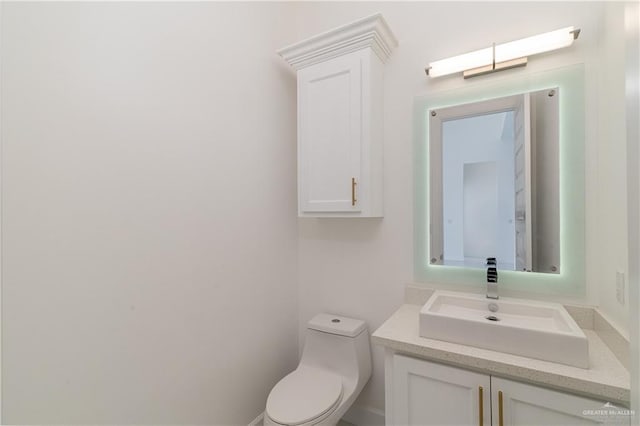 bathroom featuring toilet and vanity