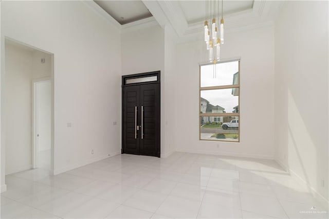 foyer featuring light tile patterned floors and ornamental molding