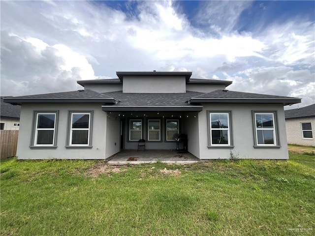 1213 Emma Elizabeth St, Weslaco, TX 78599 - back of house featuring roof with shingles, stucco siding, and a patio area