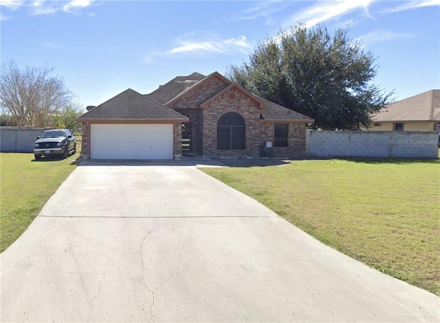 view of front of home with a garage, driveway, a front lawn, and fence