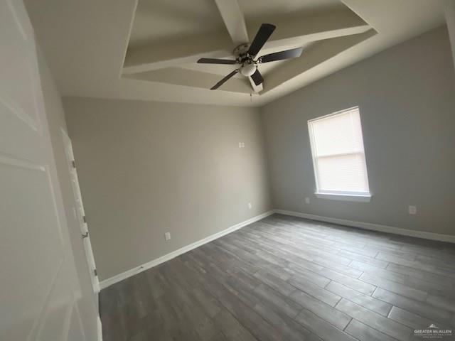 empty room with ceiling fan and dark wood-type flooring