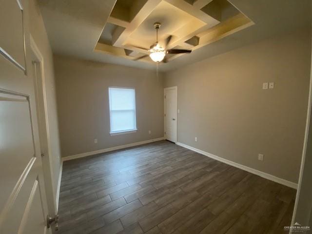 interior space featuring a tray ceiling, ceiling fan, and dark hardwood / wood-style flooring