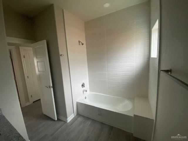 bathroom with shower / bathtub combination and wood-type flooring