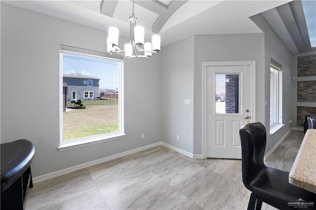 home office with a chandelier, lofted ceiling, and baseboards