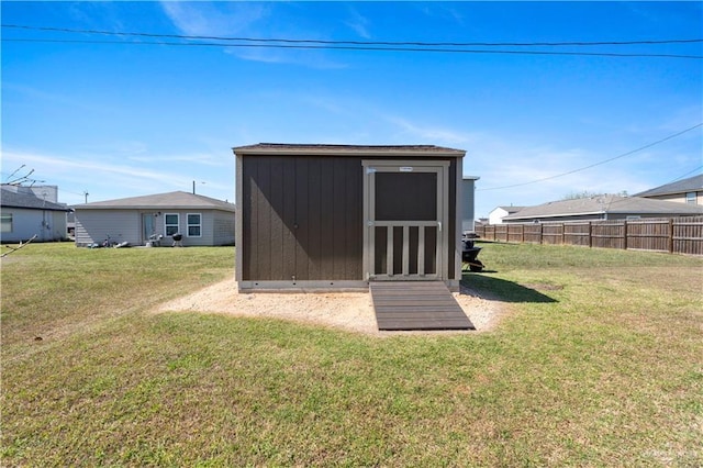 view of shed featuring fence