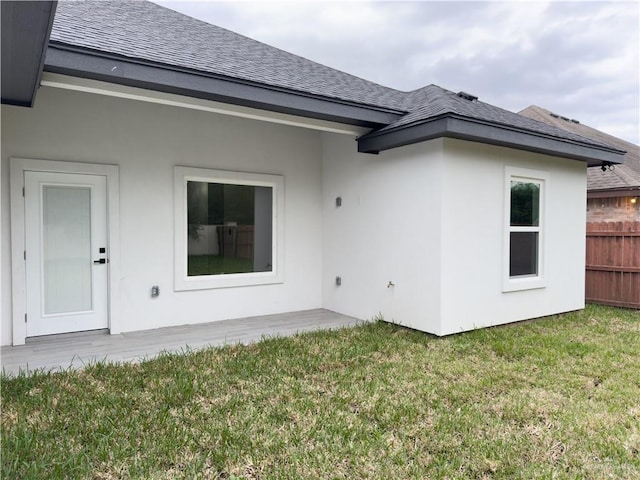 rear view of property featuring a yard