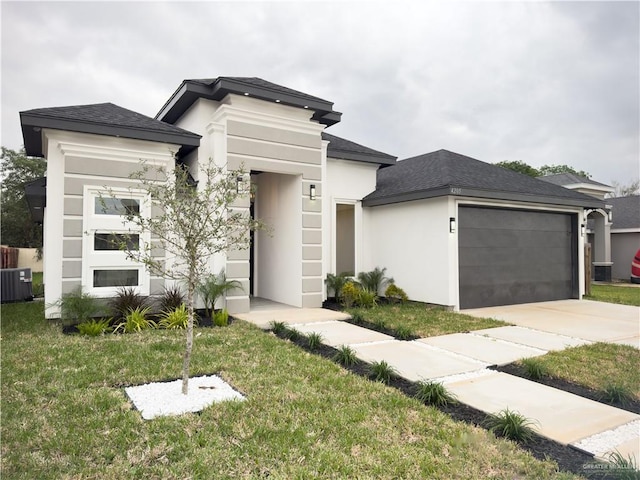 view of front facade with cooling unit, a garage, and a front lawn