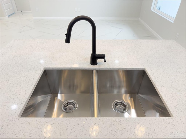 interior details featuring sink and light stone counters