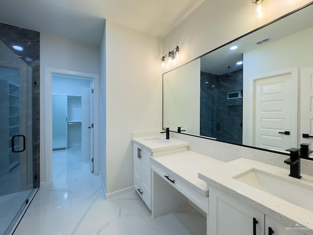 bathroom with vanity and a shower with door